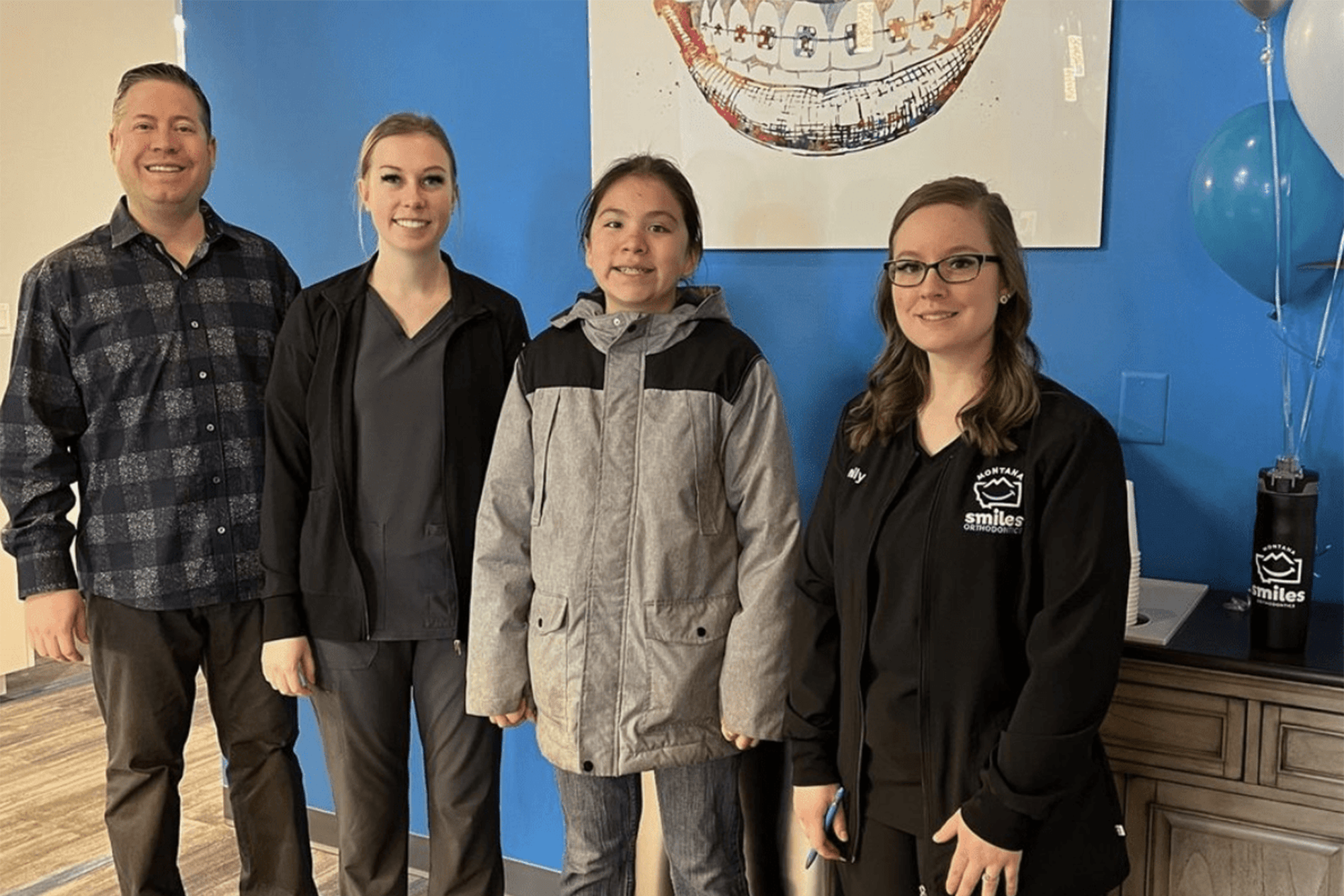 Patient celebrates with the Montana Smiles Orthodontics team in Dr. Ryan Hecht’s orthodontic office in Billings, MT