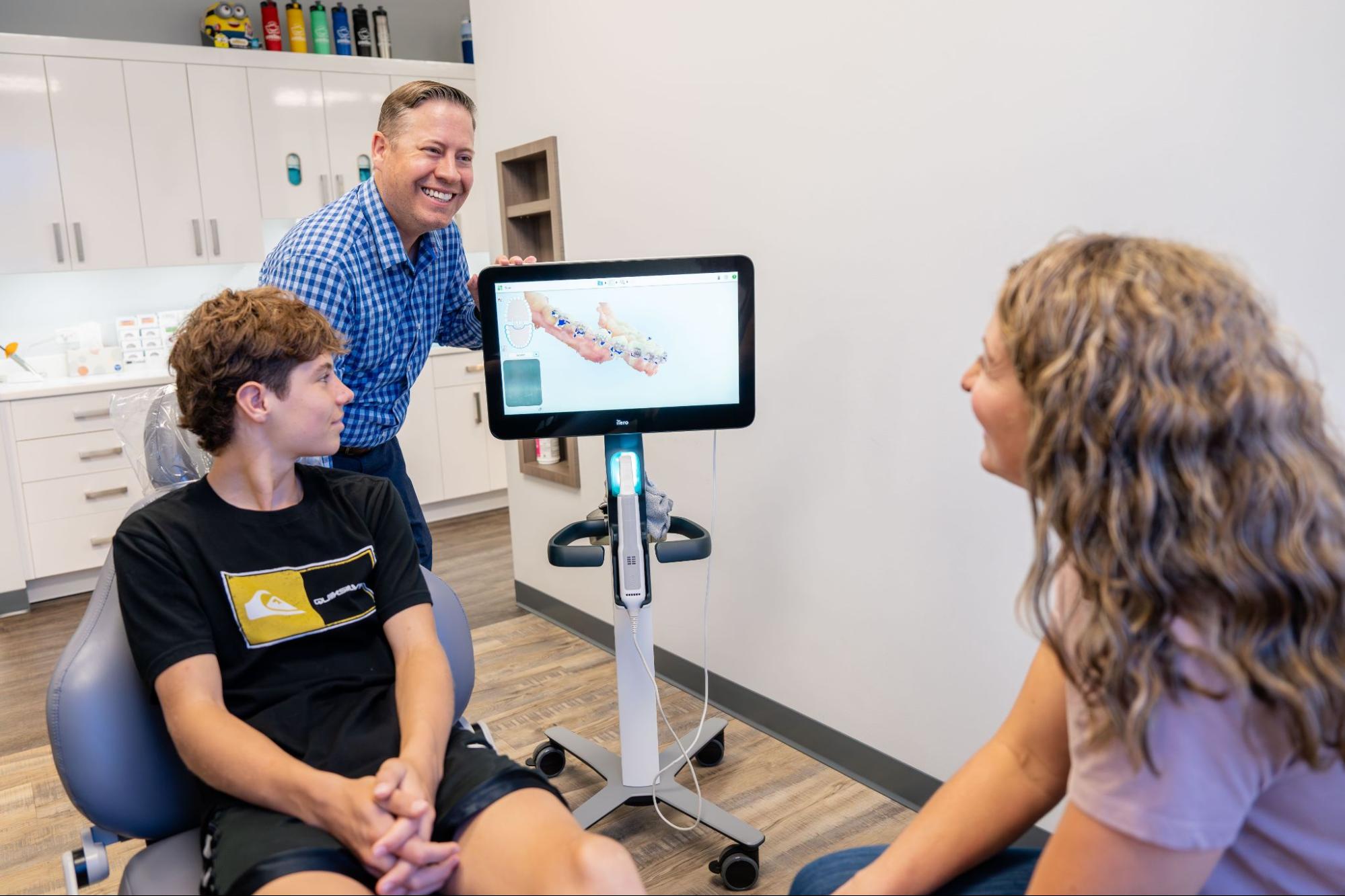 Dr. Ryan Hecht reviewing a digital treatment scan with a patient and parent at Montana Smiles Orthodontics, Billings orthodontics office